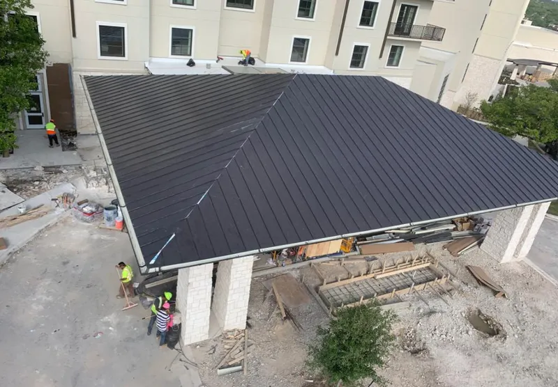 Metal roofing installation team working on a commercial building in Flatwoods
