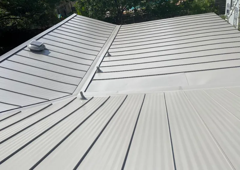 Solar attic fan installed on a metal roof for Roof Ventilation in Flatwoods